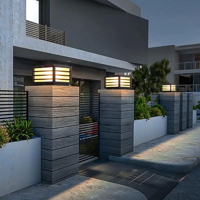 Scandinavian solar pillar lights installed on modern gate columns for warm outdoor pathway illumination
